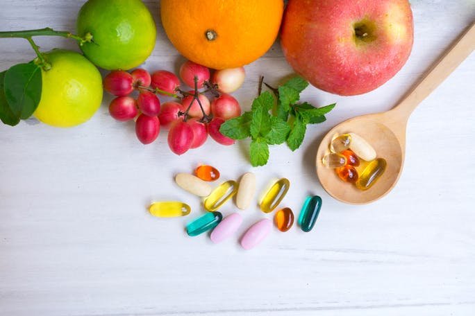 Fresh fruits and wellness supplements for balanced health